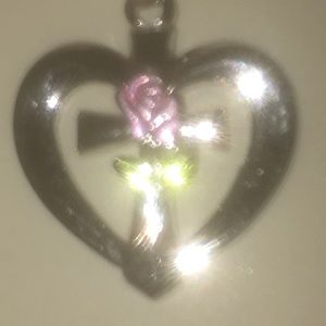 Silver heart with a cross and a pink rose in it